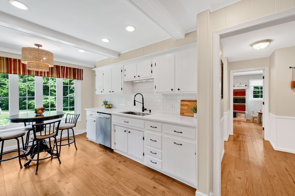 3 Mark Road Wilbraham, MA 01095 - Photo 11 of 39 a kitchen with stainless steel appliances kitchen island wooden floors stove and white cabinets