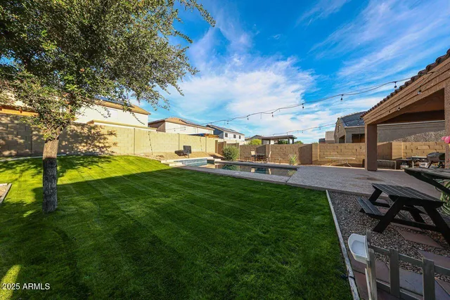 a view of backyard of house with green space