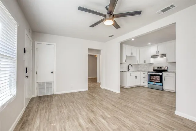 a kitchen with stainless steel appliances a refrigerator and a stove top oven