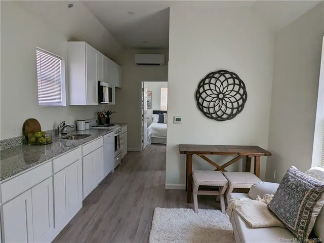 a large white kitchen with a wooden floor
