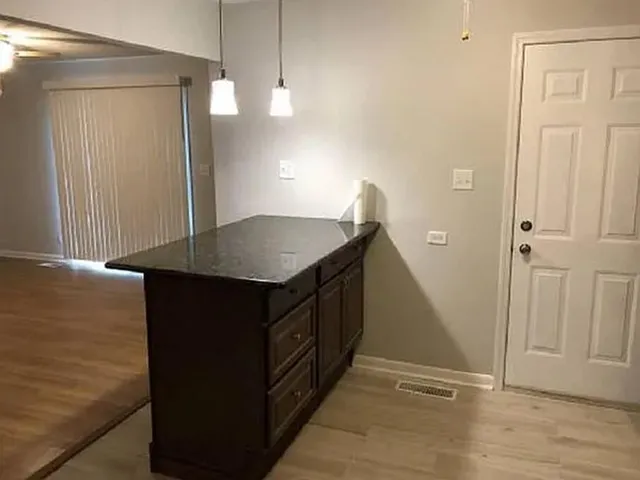 a kitchen with stainless steel appliances granite countertop a sink and a refrigerator
