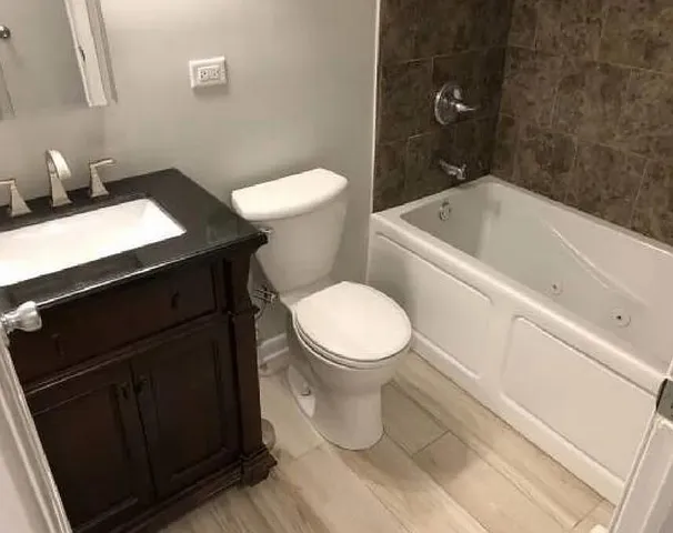 a white toilet sitting next to a bathroom sink