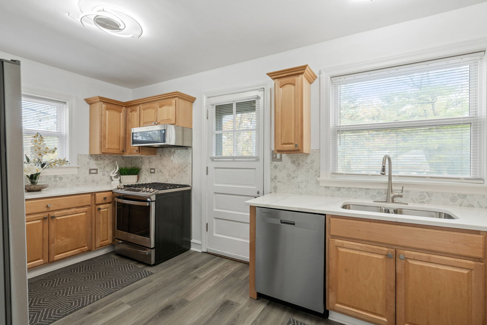 1600 Pine Road Homewood, IL 60430 - Photo 10 of 28 a kitchen with stainless steel appliances granite countertop a sink stove cabinets and wooden floor