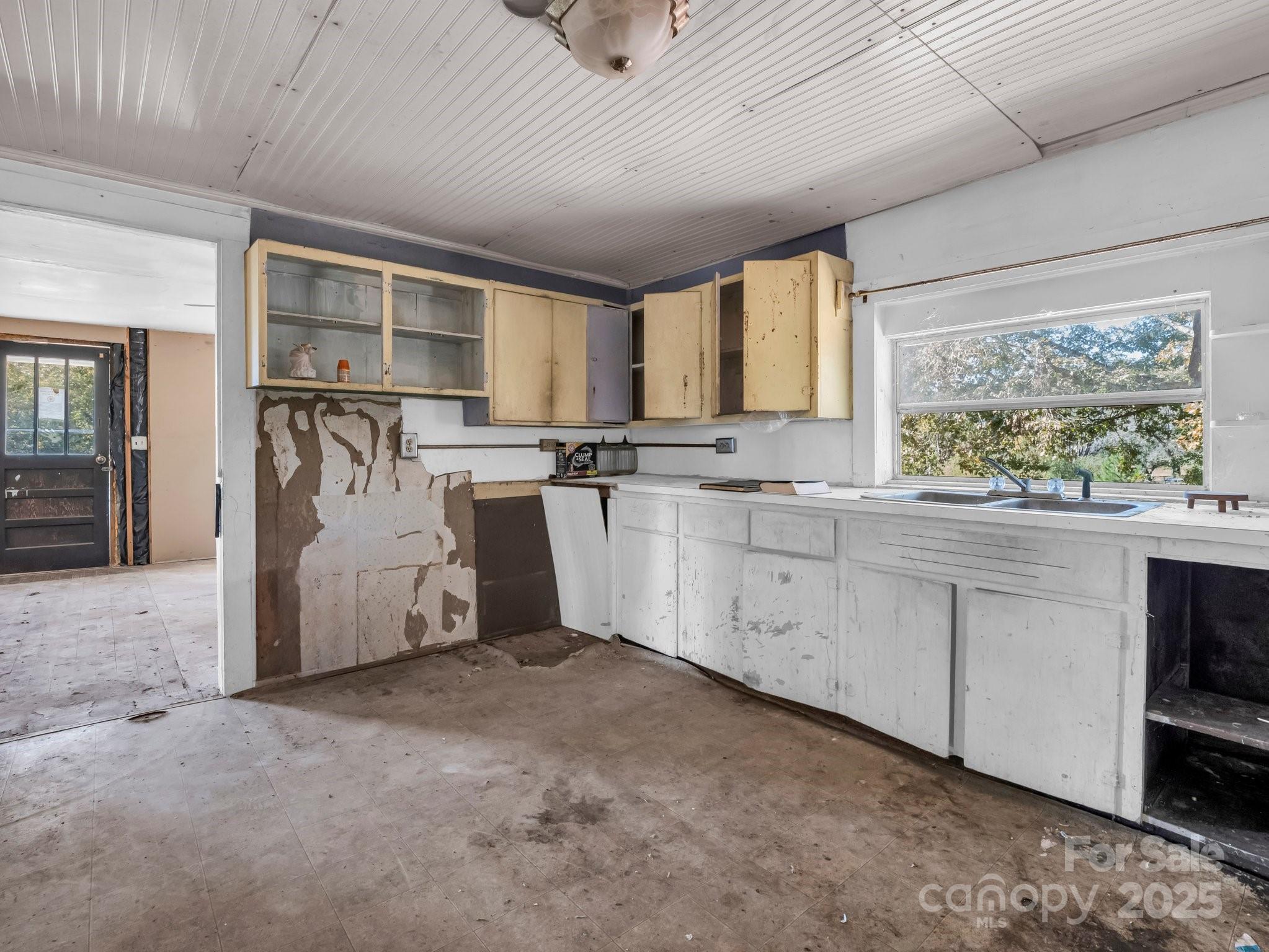 6271 Highway 108 Mill Spring, NC 28756 - Photo 11 of 35 a kitchen with granite countertop cabinets stainless steel appliances a sink and a large window