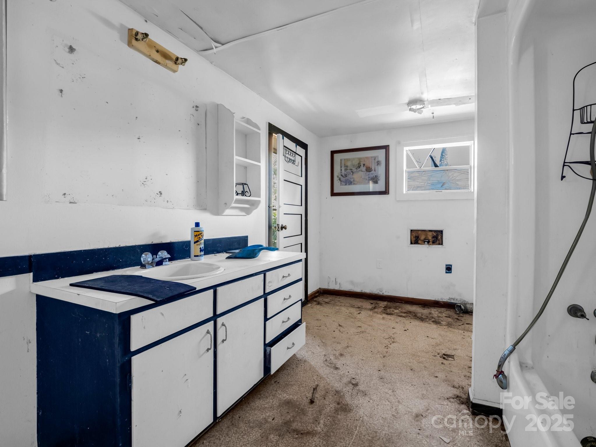 6271 Highway 108 Mill Spring, NC 28756 - Photo 14 of 35 a utility room with cabinets washer and dryer