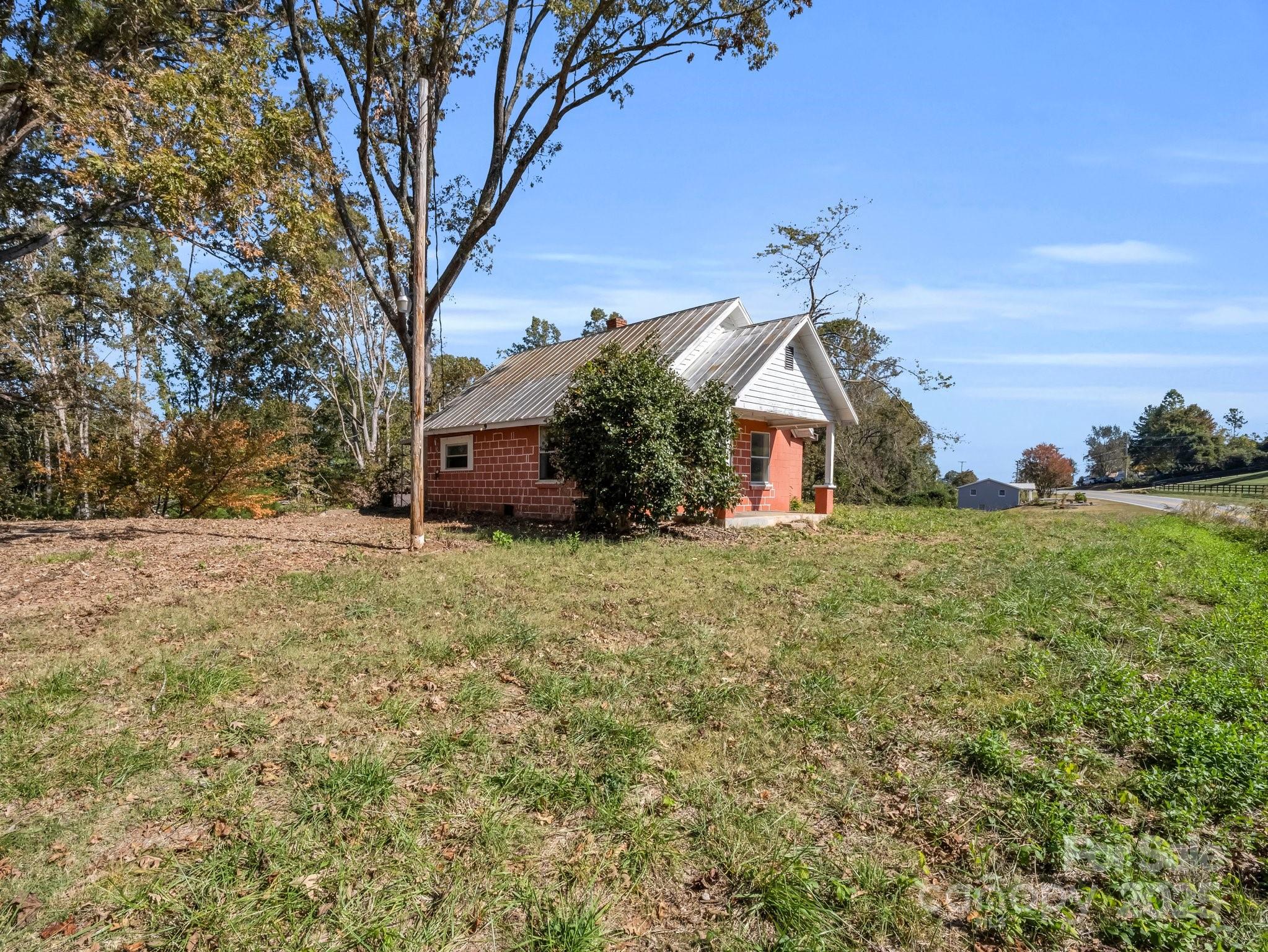 6271 Highway 108 Mill Spring, NC 28756 - Photo 22 of 35 a front view of a house with a yard