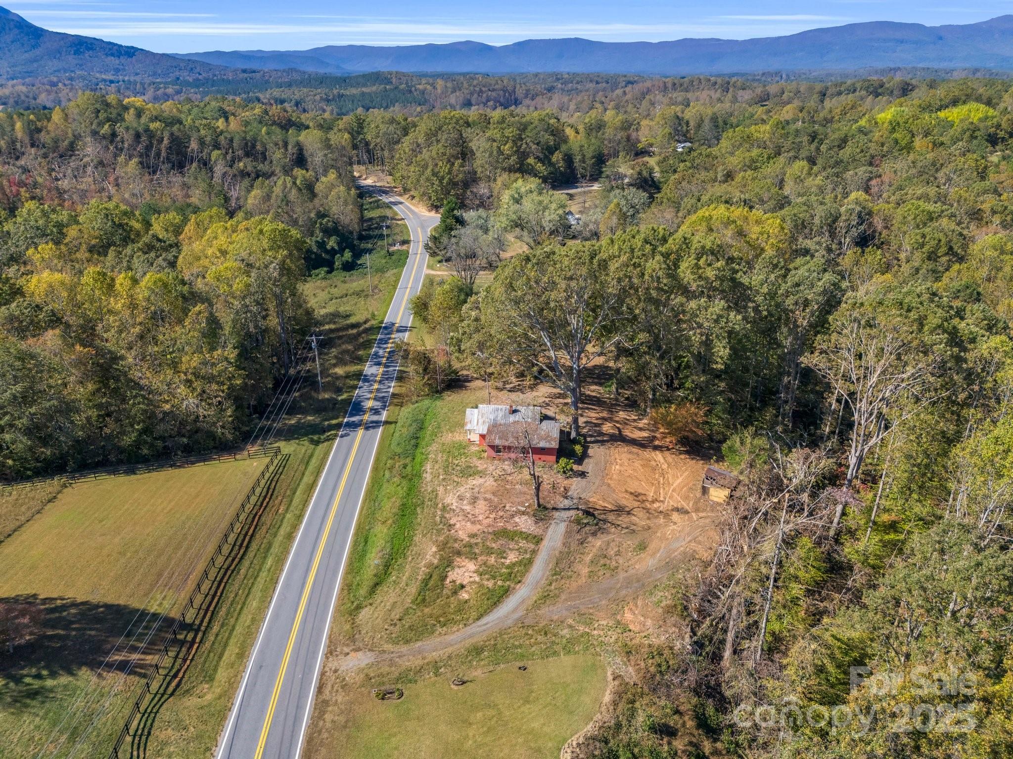 6271 Highway 108 Mill Spring, NC 28756 - Photo 31 of 35 a view of a city with lush green forest