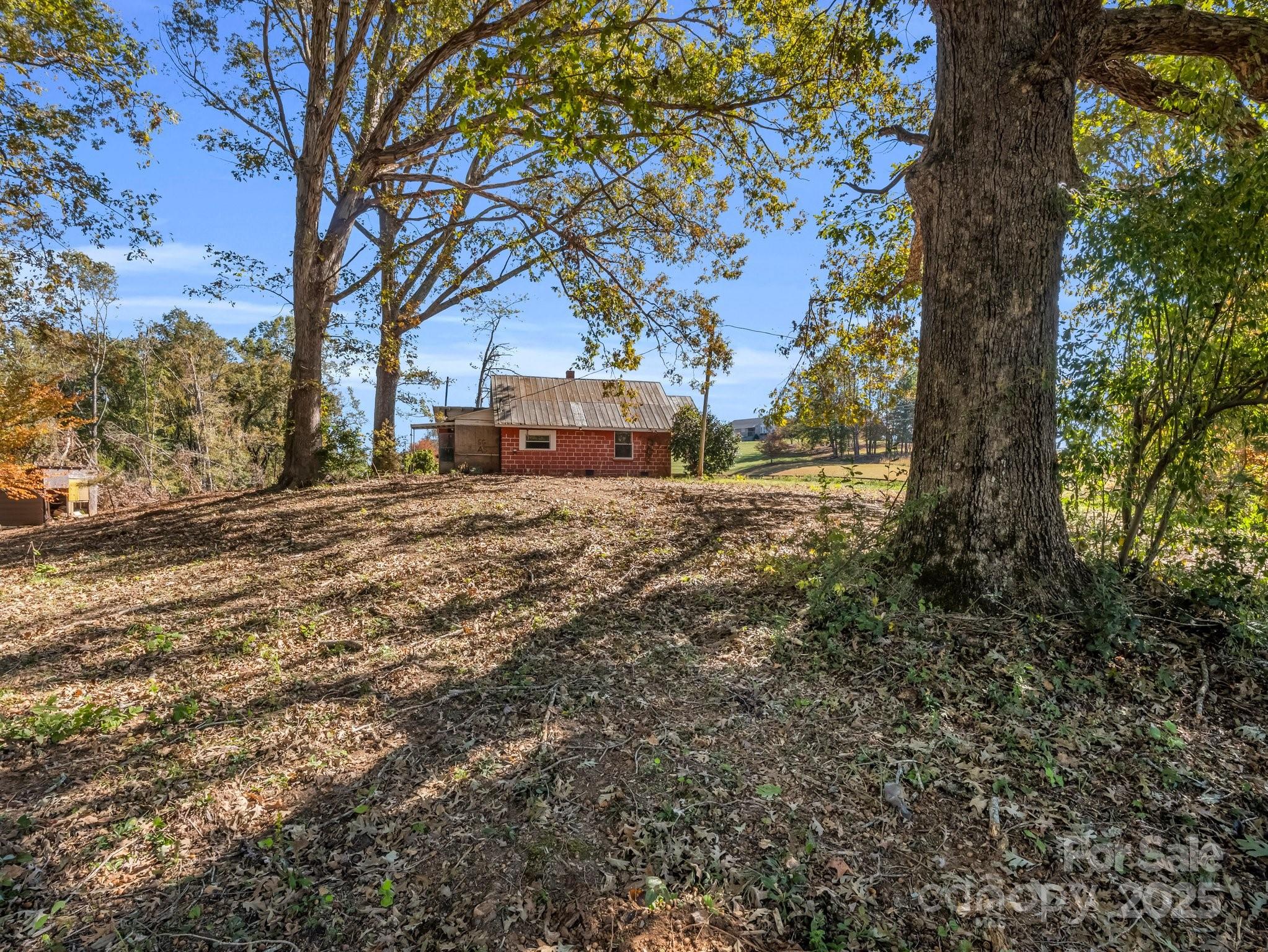6271 Highway 108 Mill Spring, NC 28756 - Photo 5 of 35 a view of a yard with wooden fence