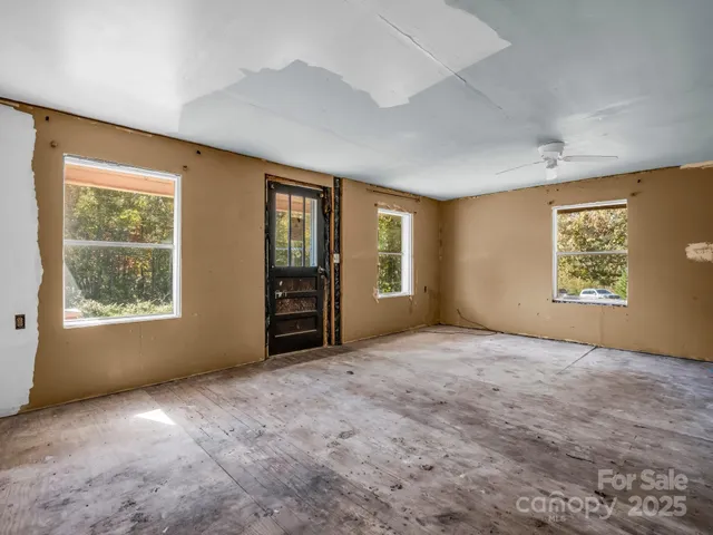 an empty room with a empty space and windows