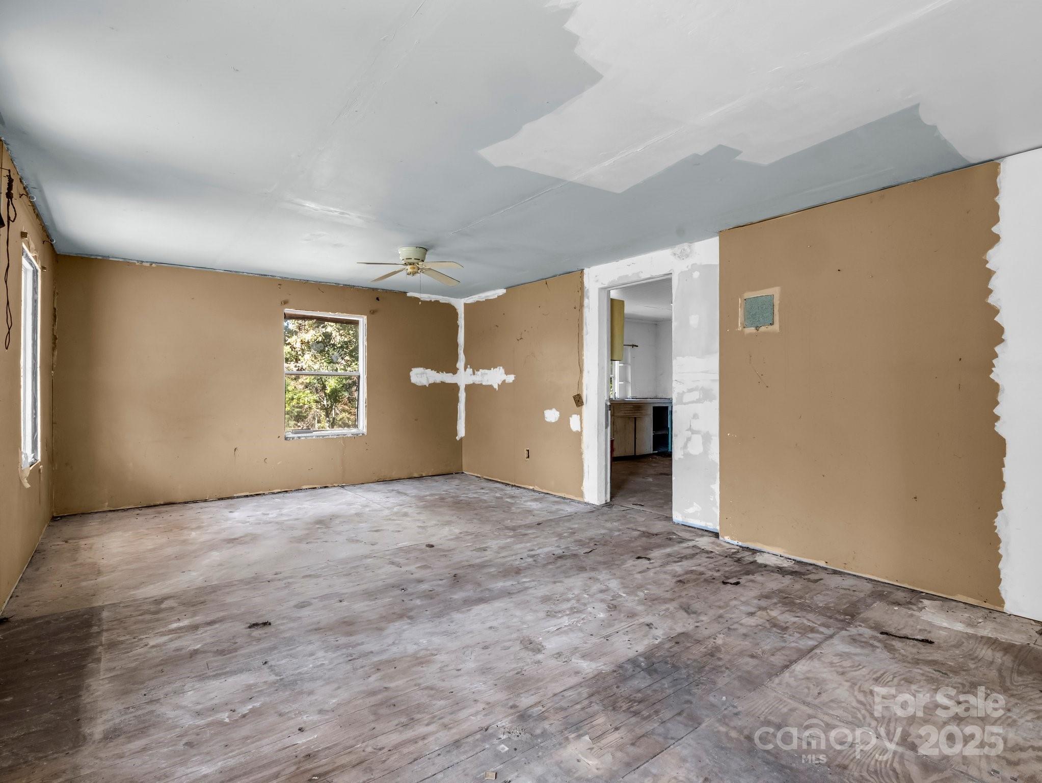 6271 Highway 108 Mill Spring, NC 28756 - Photo 9 of 35 an empty room with a empty space and windows