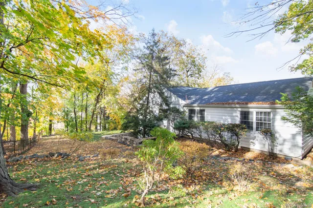 a view of house with outdoor seating area