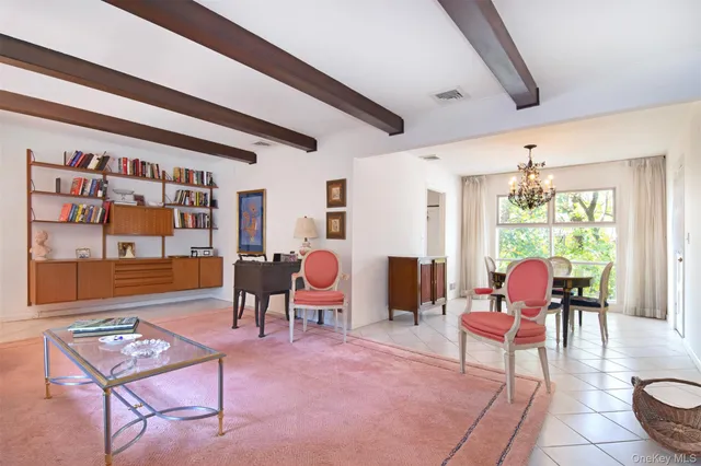 a living room with furniture and a floor to ceiling window