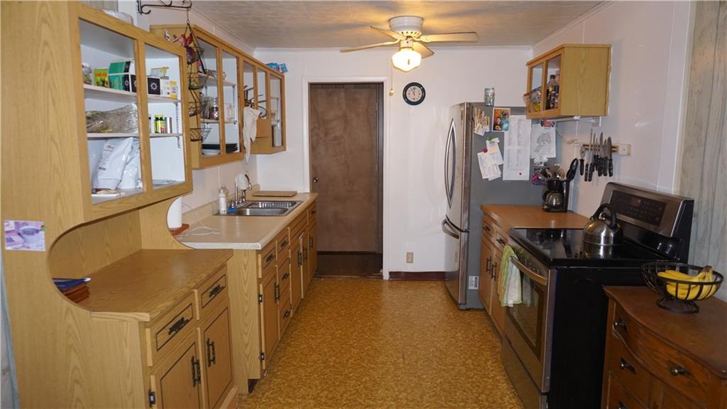 1414 Ridge Road Jeannette, PA 15644 - Photo 4 of 24 Kitchen comes equipped with newer electric stove and refrigerator (washer and dryer area also included)