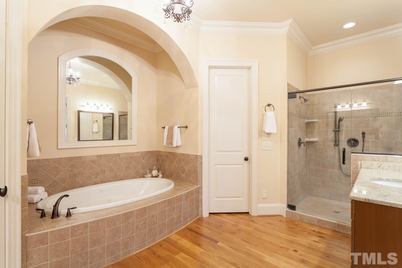821 Keith Road Wake Forest, NC 27587 - Photo 11 of 25 The spa-like master bath features a luxurious soaking tub and large walk-in shower.