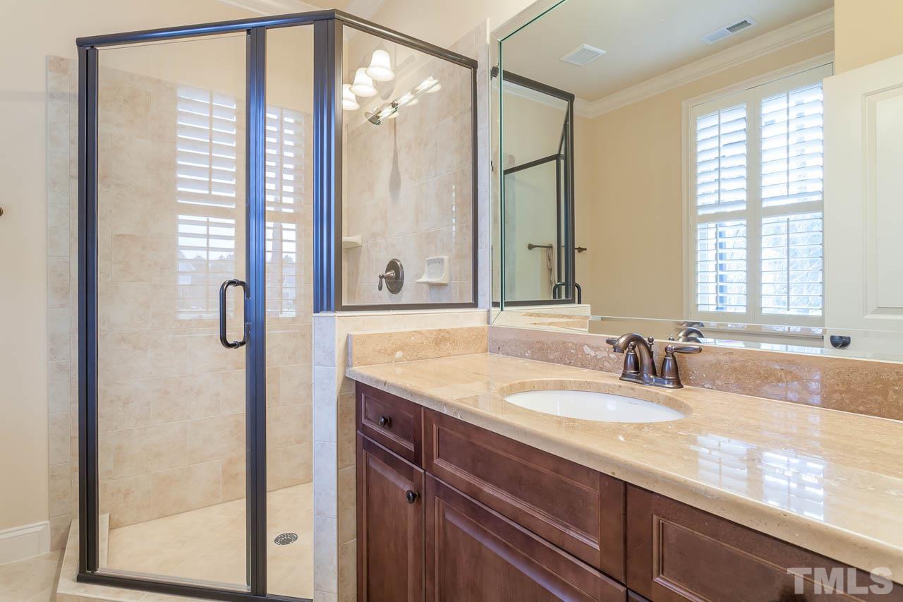 821 Keith Road Wake Forest, NC 27587 - Photo 16 of 25 This bathroom offers a large walk in shower with tile surround.