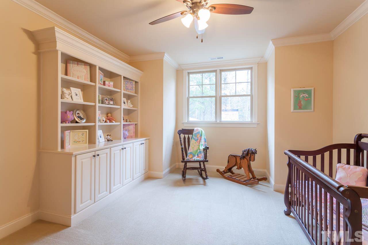 821 Keith Road Wake Forest, NC 27587 - Photo 19 of 25 This delightful bedroom features custom built-in bookcases, 2 closets, ceiling fan and planation shutters.
