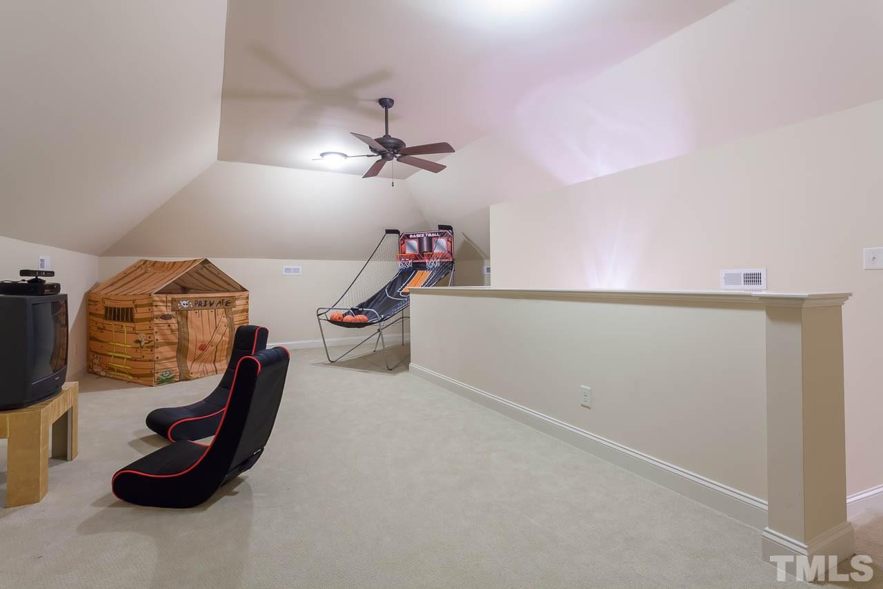 821 Keith Road Wake Forest, NC 27587 - Photo 22 of 25 The 3rd floor offers the perfect spot for fun and games for all! There is additional attic storage off the rec room.