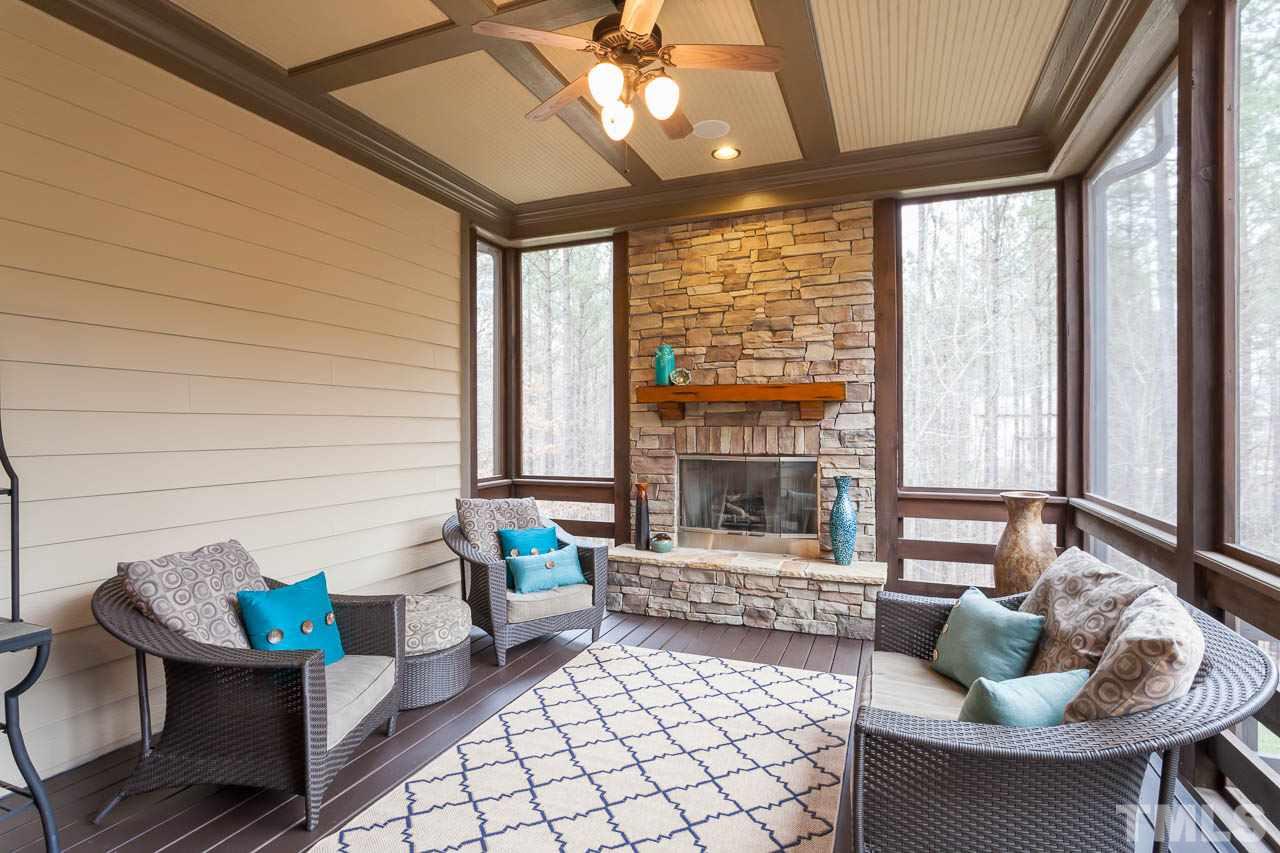 821 Keith Road Wake Forest, NC 27587 - Photo 23 of 25 The screen porch overlooks the backyard and adjoins the large deck and the breakfast room. It features a beautiful fireplace with stone surround.