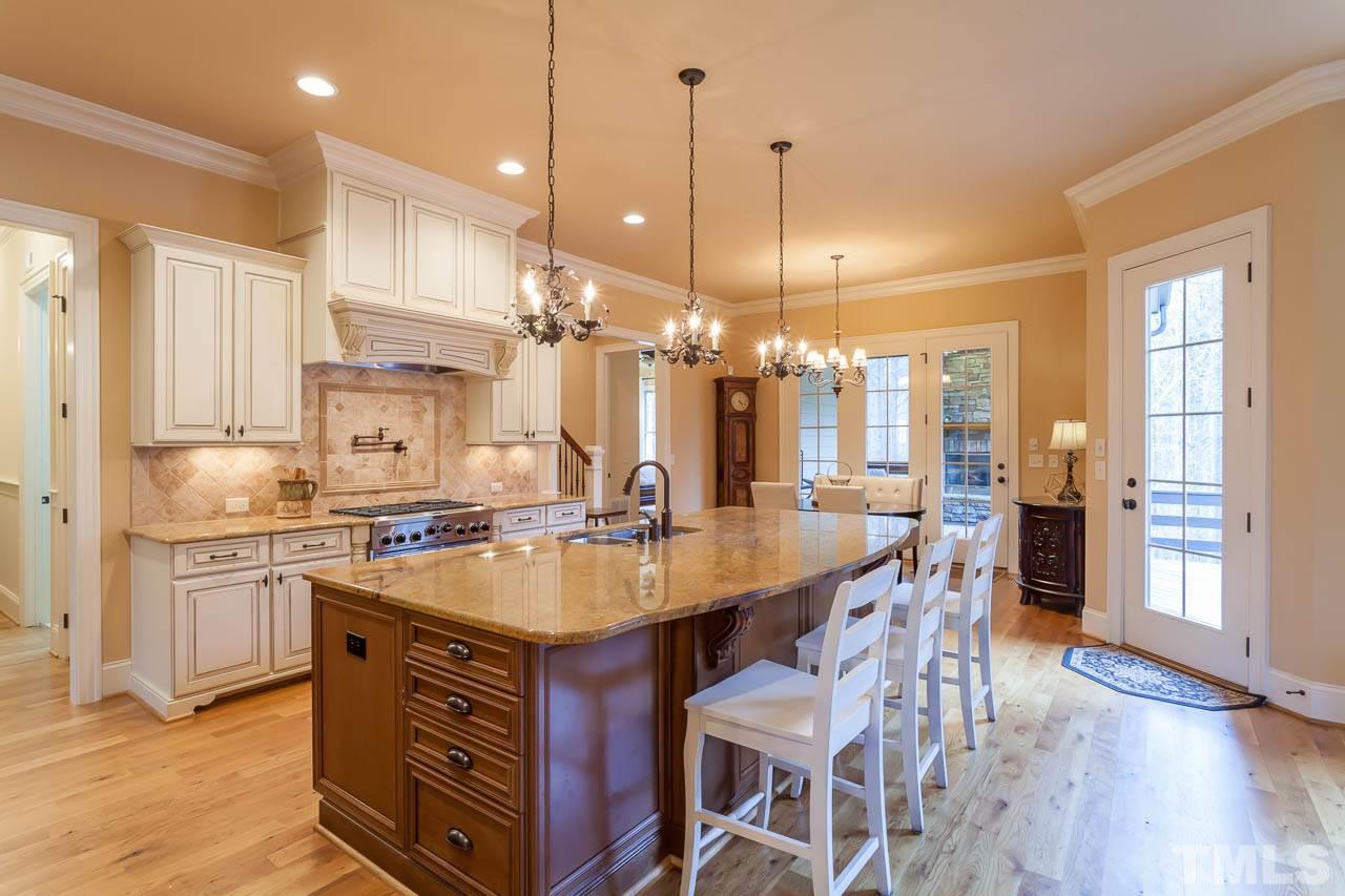 821 Keith Road Wake Forest, NC 27587 - Photo 4 of 25 The well-appointed kitchen offers a large work island, gas range, pot-filler, stainless appliances, granite counters, 3 crystal pendant lights, and a large walk-in pantry.