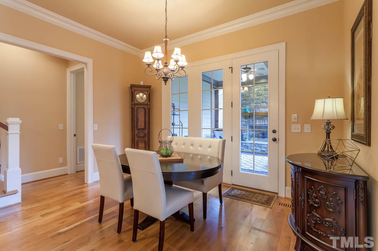821 Keith Road Wake Forest, NC 27587 - Photo 6 of 25 The breakfast room is open to the kitchen and the family room. It features hardwood floors and crown molding.