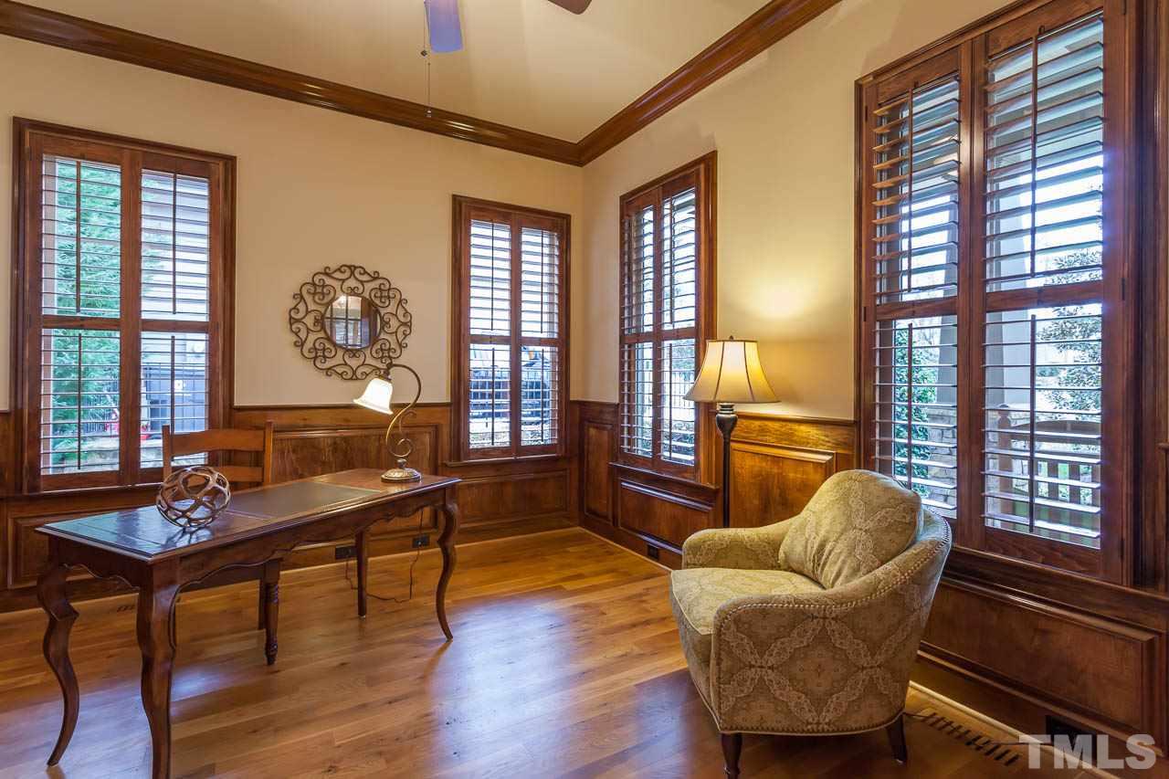 821 Keith Road Wake Forest, NC 27587 - Photo 9 of 25 Double French doors lead to the beautiful office that features hardwood floors, crown molding, wainscoting and plantation shutters.