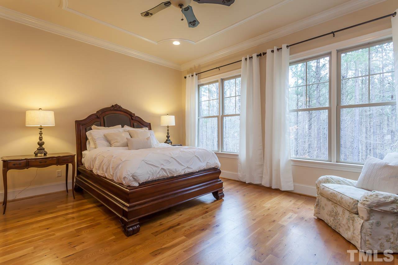 821 Keith Road Wake Forest, NC 27587 - Photo 10 of 25 The 1st floor master features crown molding, recessed lighting, crown molding,ceiling fan and a large walk in closet with custom shelving.