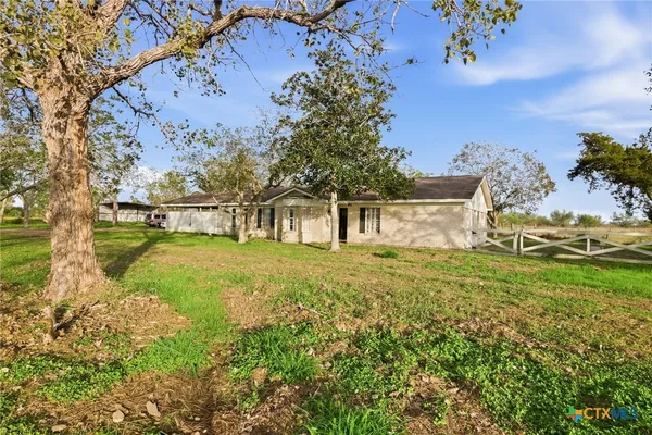 a view of an house with backyard space and garden
