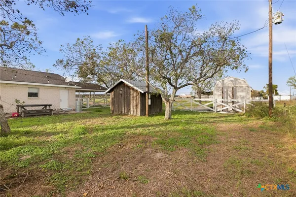 a front view of house with yard and trees