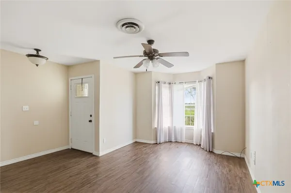 wooden floor in an empty room with a window