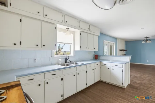 a kitchen with sink and cabinets