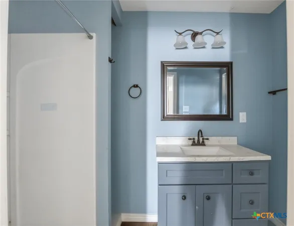 a bathroom with a sink and a mirror