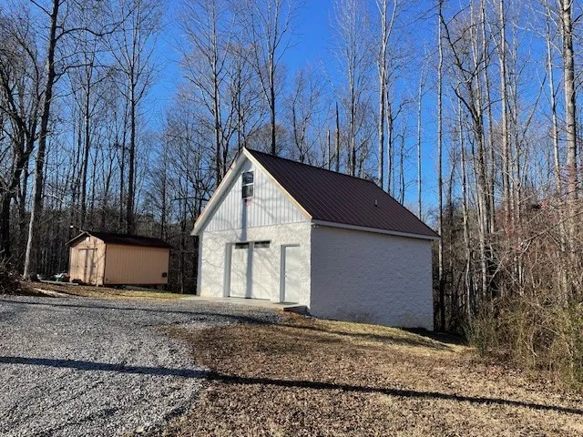 a view of a house with backyard and trees