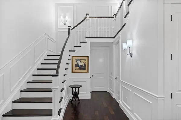 a view of entryway with wooden floor and stairs