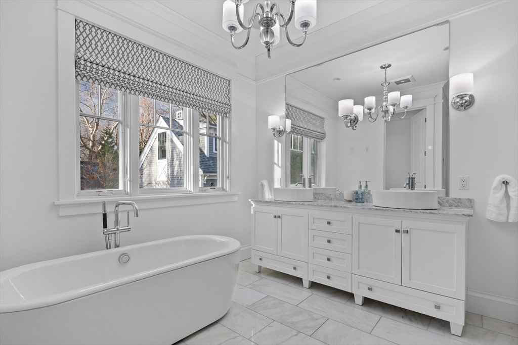 75 Goddard Avenue Brookline, MA 02445 - Photo 17 of 27 a bath room with a mirror and a sink