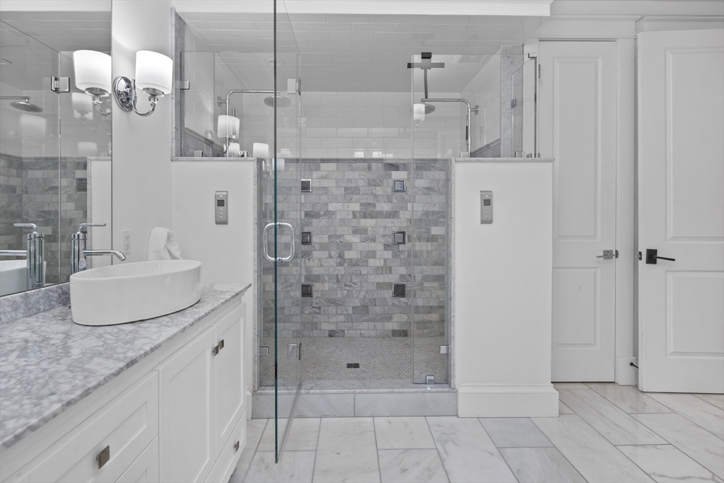 75 Goddard Avenue Brookline, MA 02445 - Photo 18 of 27 a bathroom with double vanity and a shower