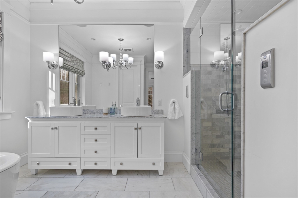 75 Goddard Avenue Brookline, MA 02445 - Photo 20 of 27 a bathroom with a granite countertop sink mirror and a shower