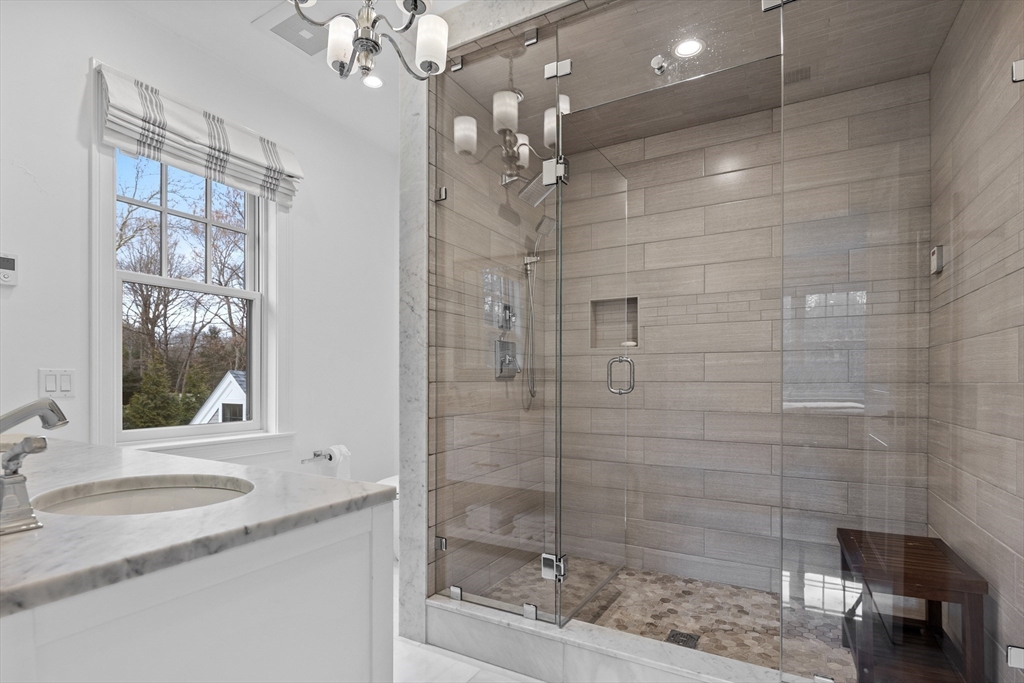 75 Goddard Avenue Brookline, MA 02445 - Photo 22 of 27 a bathroom with a shower sink and mirror