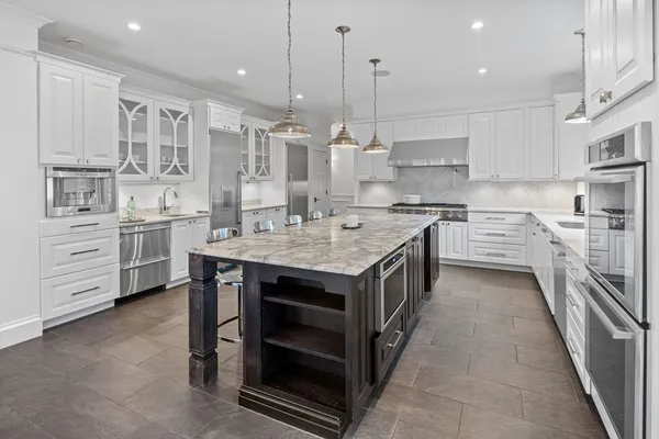 a kitchen with stainless steel appliances granite countertop a stove oven and a sink
