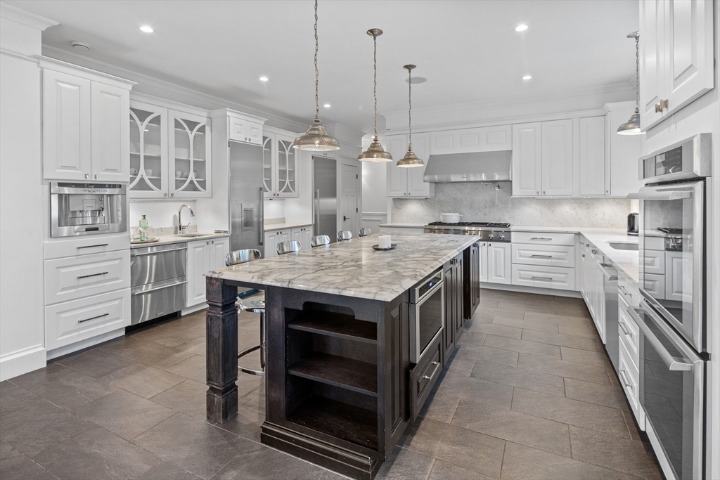 75 Goddard Avenue Brookline, MA 02445 - Photo 6 of 27 a kitchen with stainless steel appliances granite countertop a stove oven and a sink