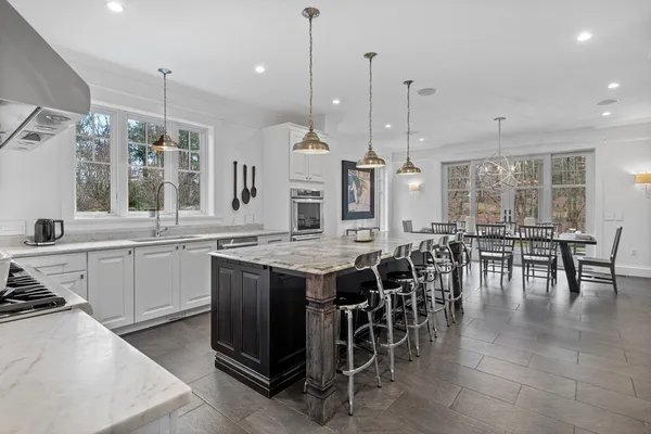 a large kitchen with lots of counter space and dining table