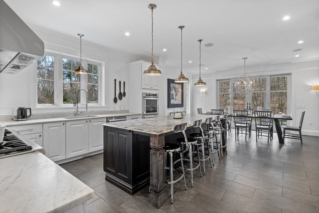 75 Goddard Avenue Brookline, MA 02445 - Photo 7 of 27 a large kitchen with lots of counter space and dining table
