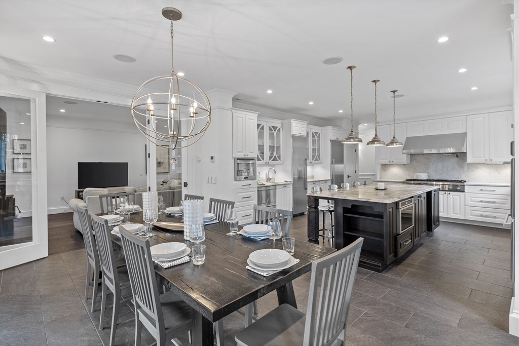 75 Goddard Avenue Brookline, MA 02445 - Photo 8 of 27 a large kitchen with a table and chairs