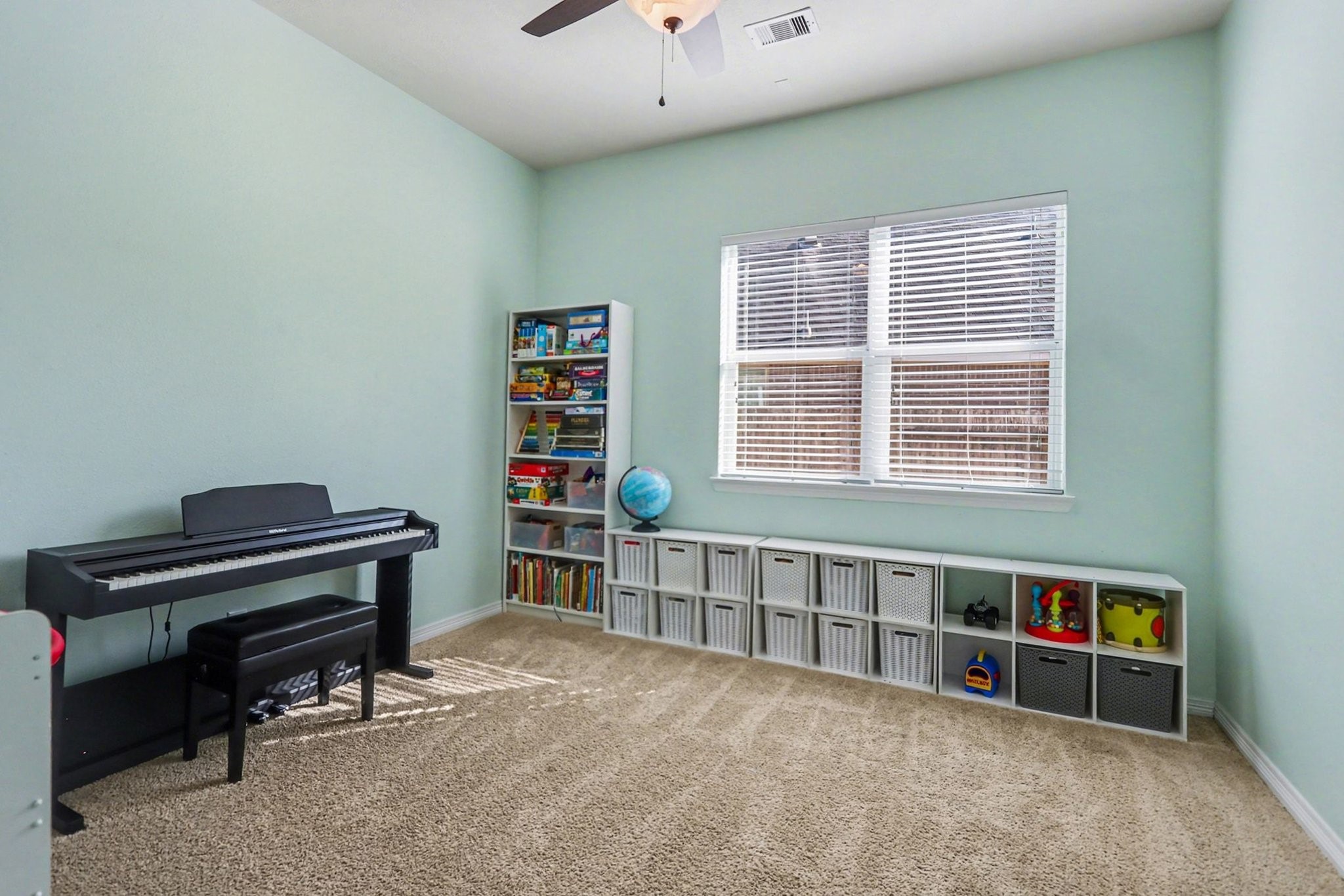 27006 Cliff Pointe Lane Katy, TX 77494 - Photo 17 of 34 Versatile secondary bedroom with soft natural light and neutral finishes—ideal for a guest room, playroom, or additional office space.