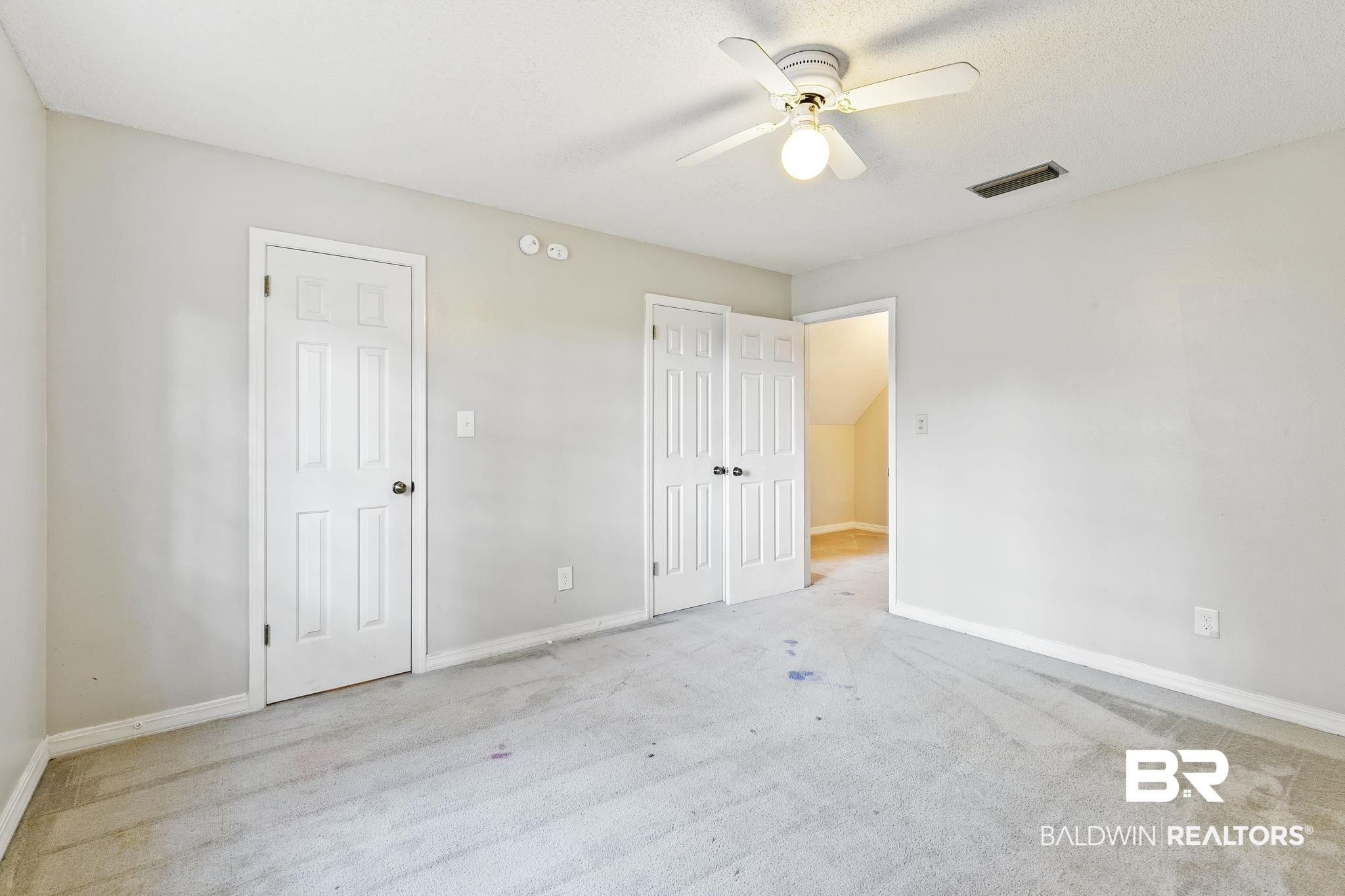 474 Ridgewood Drive Daphne, AL 36526 - Photo 41 of 57 Unfurnished bedroom featuring ceiling fan, light carpet, and a textured ceiling