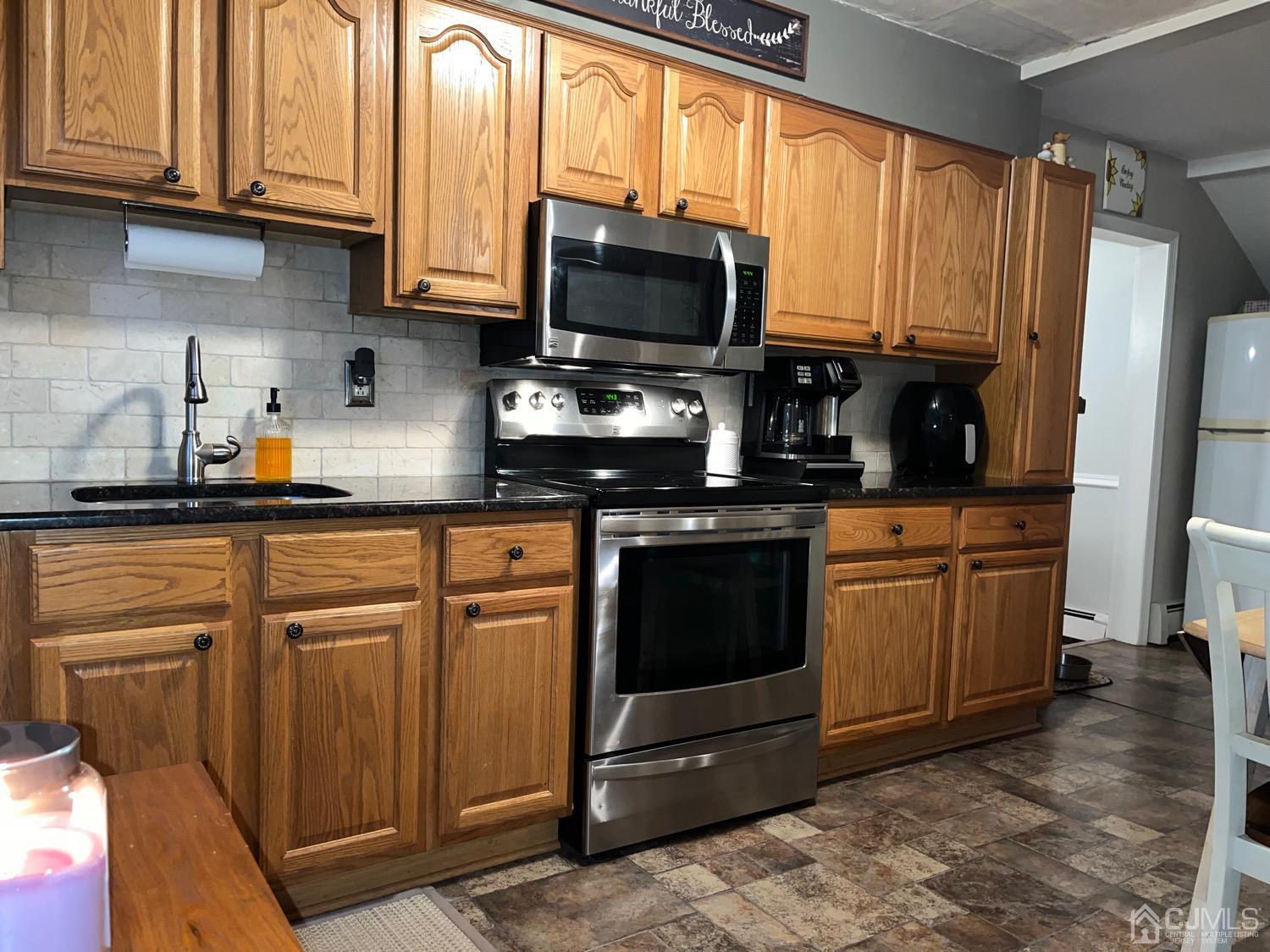 34 Dalton Place Edison, NJ 08817 - Photo 17 of 20 a kitchen with stainless steel appliances granite countertop a stove a sink dishwasher and a microwave oven with cabinets