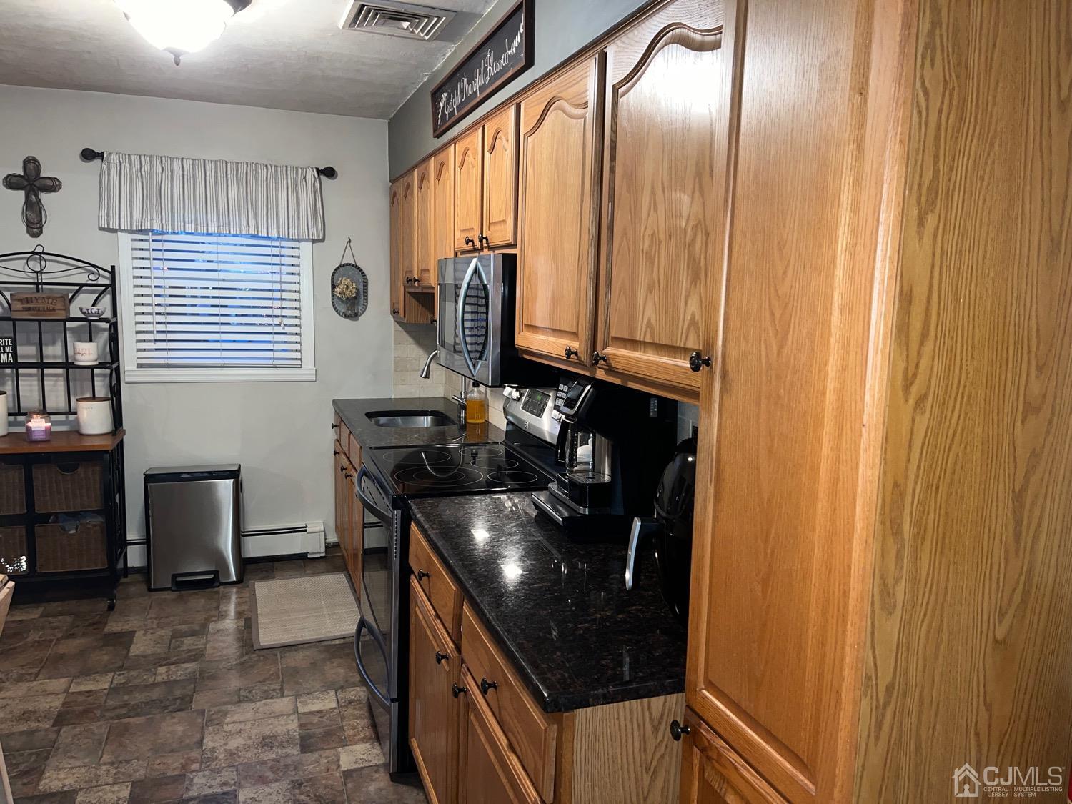 34 Dalton Place Edison, NJ 08817 - Photo 20 of 20 a kitchen with a sink a stove and cabinets