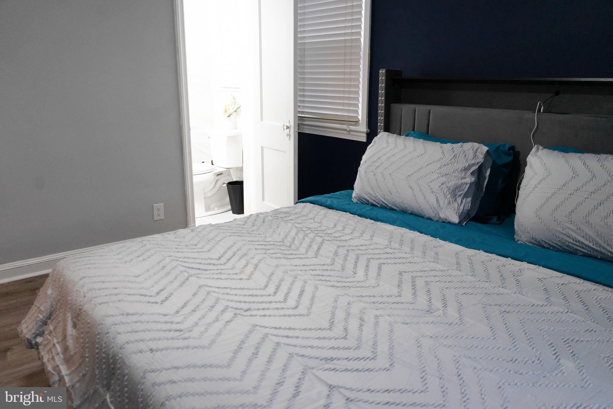 7329 12th Street Northwest Washington, DC 20012 - Photo 15 of 20 a large white bed in a small room