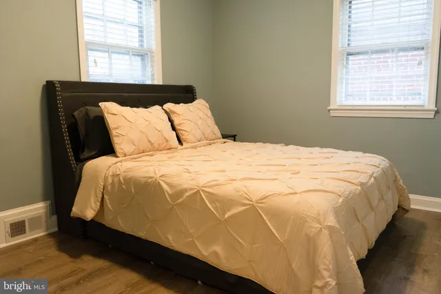 a bed sitting in a bedroom next to a window