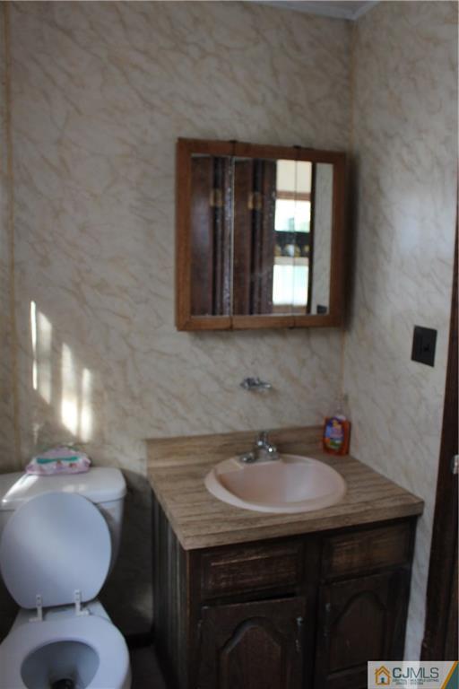 317 Ridge Road Dayton, NJ 08810 - Photo 11 of 16 a bathroom with a toilet sink and mirror