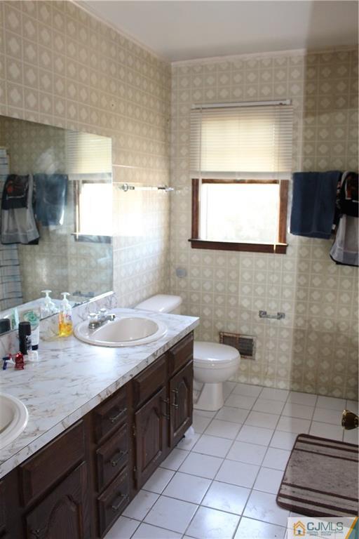 317 Ridge Road Dayton, NJ 08810 - Photo 14 of 16 a bathroom with a toilet sink and mirror